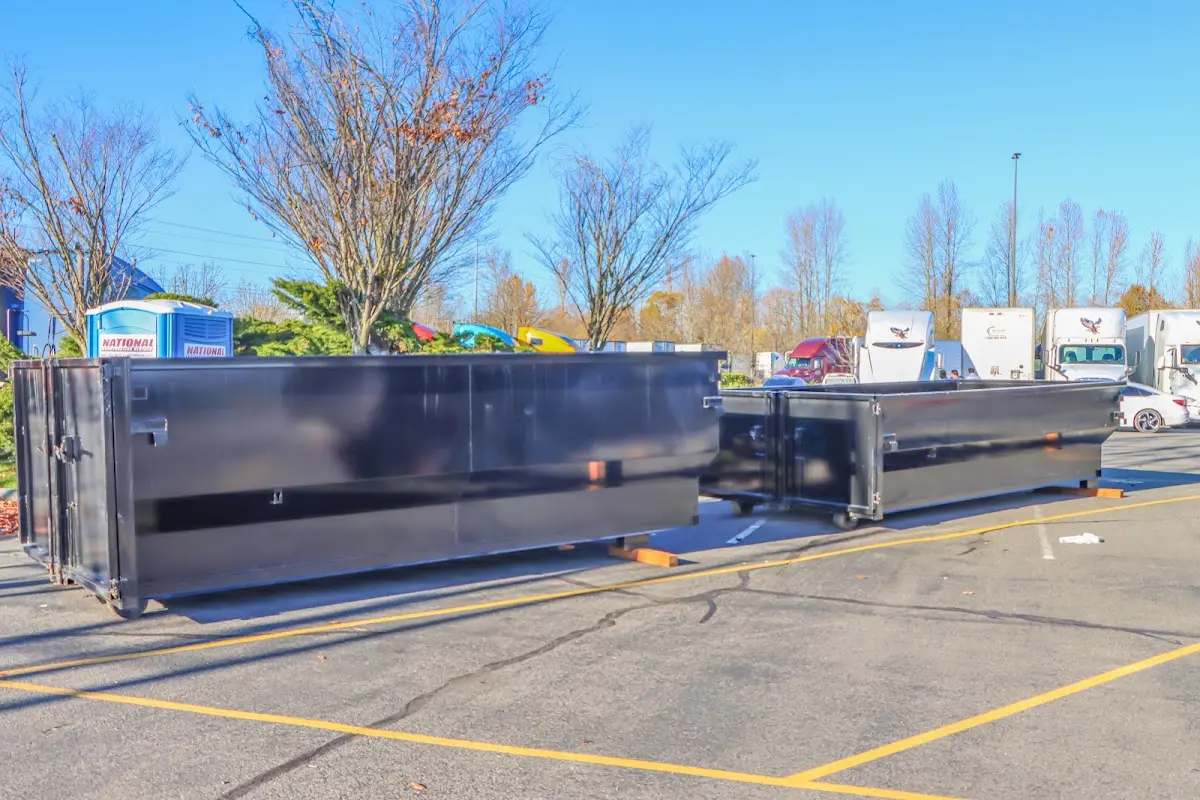 Professional dumpster rental service with roll-off container on residential driveway in Swannanoa